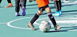 a kid playing on the soccer mini-pitch at Delhi park