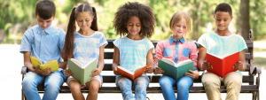 kids reading on a bench