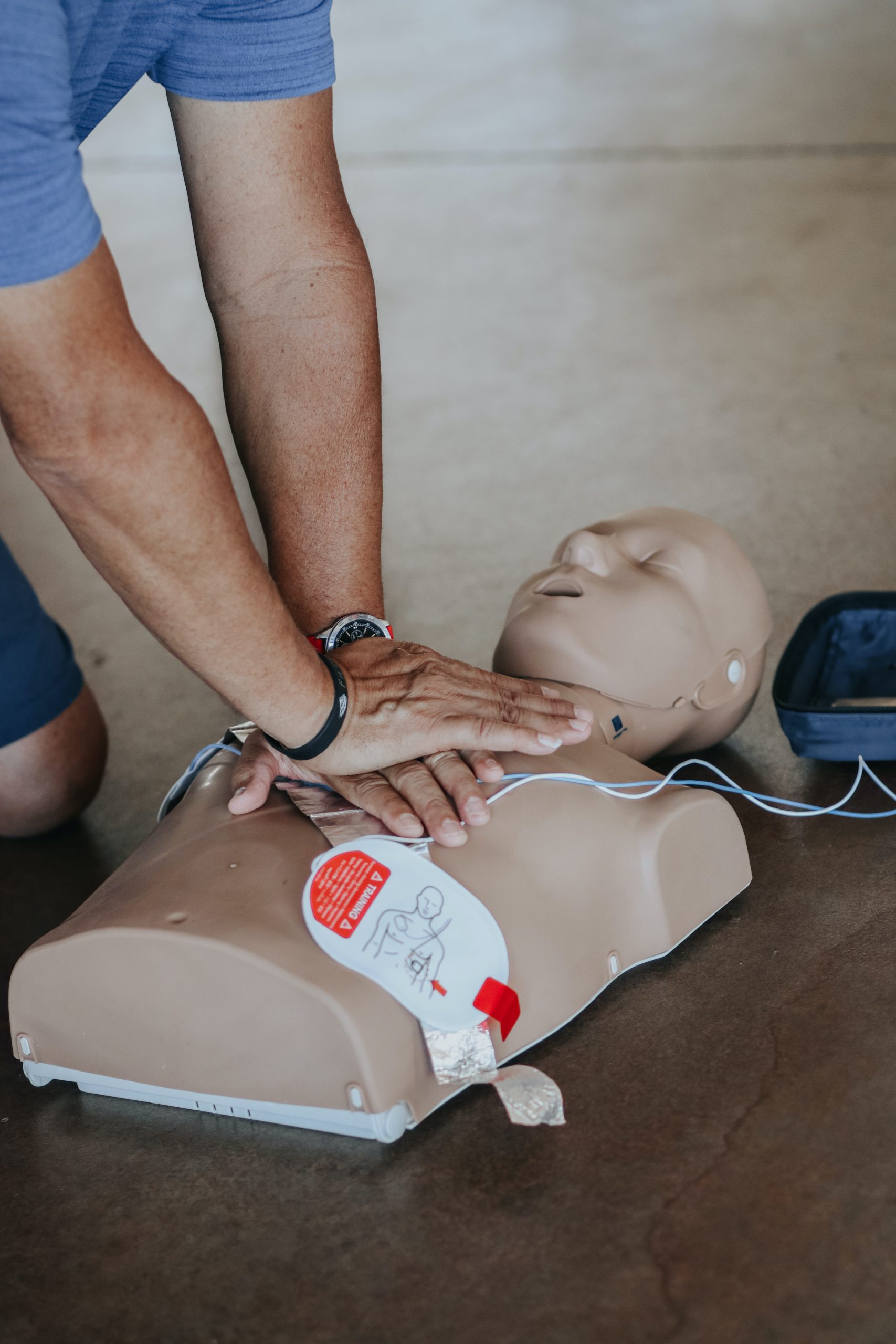 person performing CPR on a dummy