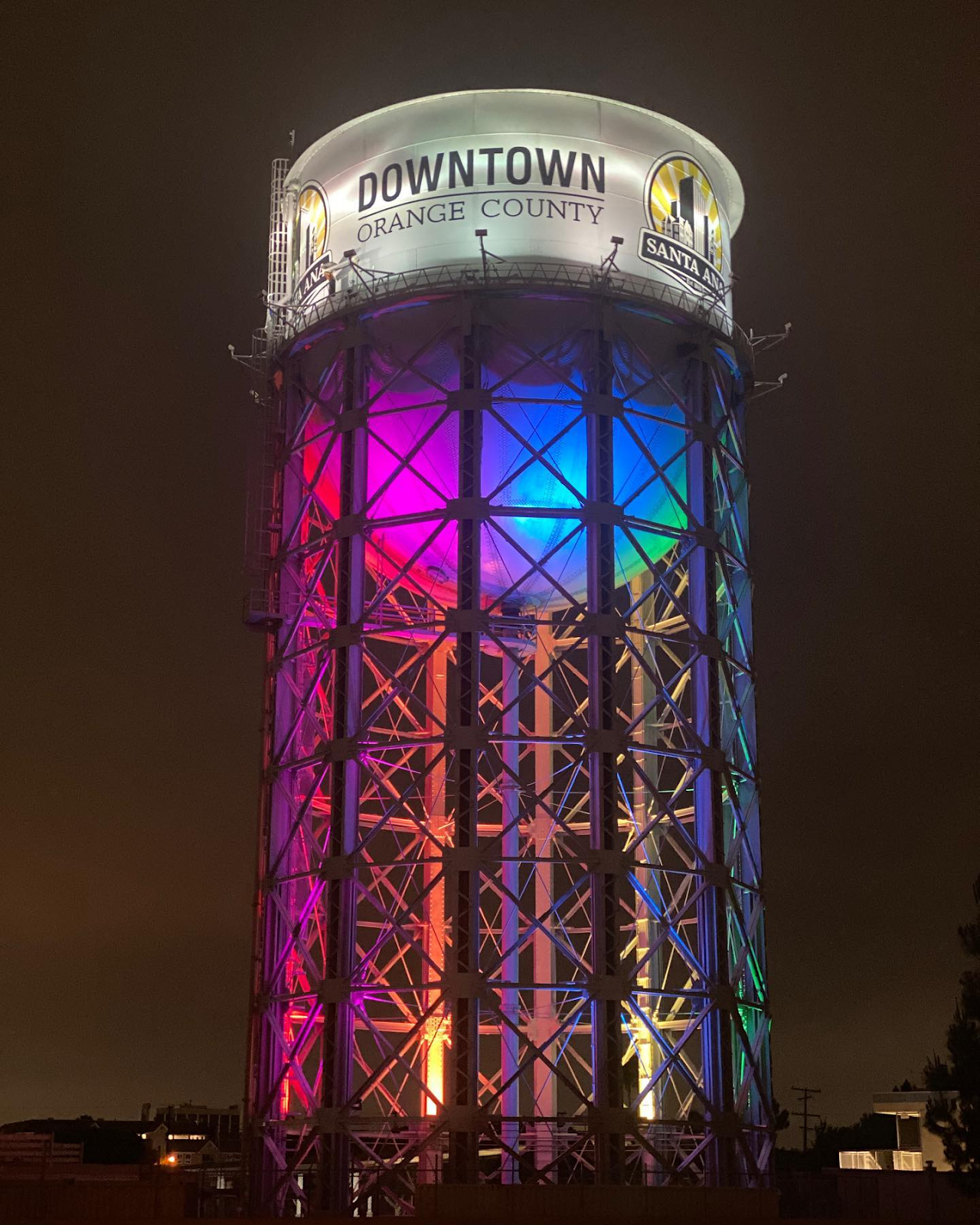 Santa Ana Water Tower lit up rainbow for pride month