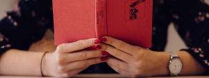 person holding red book