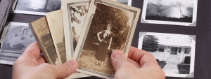 Person holding old black and white photos