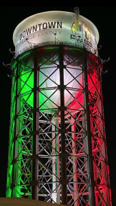 Water Tower lit in green, white, and red