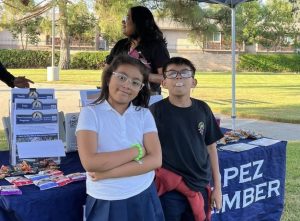 two kids pose for a photo in front of booth