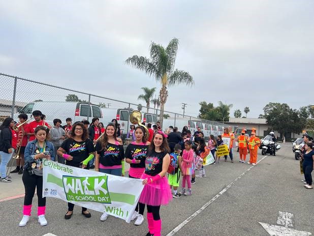 Public Works Agency and Santa Ana Police Department staff joined local students for National Walk to School Day on Oct. 5. The annual event encourages students and parents to increase their physical activity, practice pedestrian and bicycle safety, reduce traffic congestion and strengthen connections between families, schools and communities. Public Works Agency Traffic Engineer Frank Orellana and the Cone Head Team joined about 400 students from Carver Elementary School. They demonstrated to the students how to use the crosswalk and cross the street safely. The Cone Head Team was enthusiastically received by the students and all who attended the event. Santa Ana Police Department walked with students and shared safety tips at Carver Elementary and Wilson Elementary.