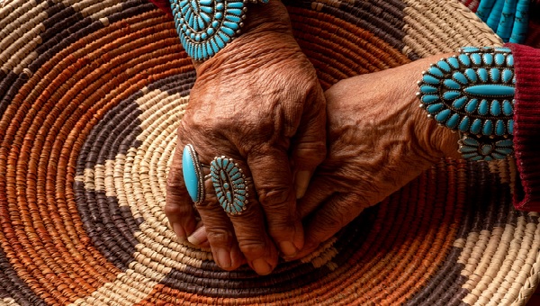 hands holding native American rug