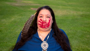 Native American Woman with red hand print on face