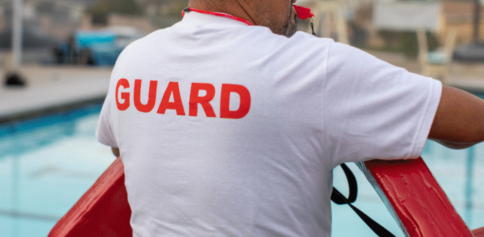 Lifeguard posing poolside