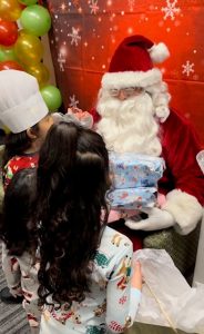 Children at the Navigation center are happy to see Santa