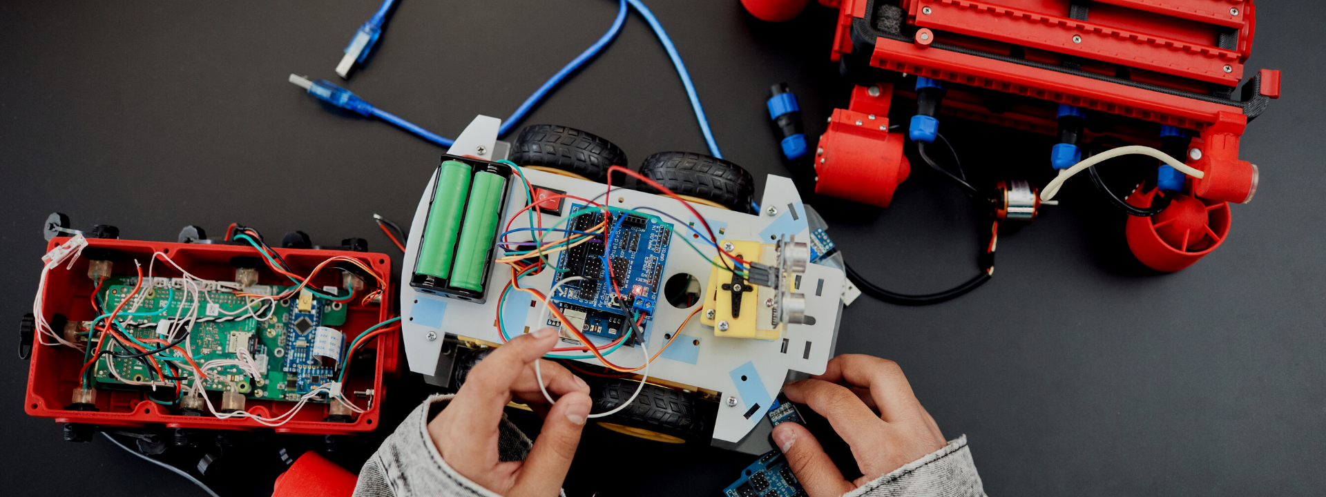 person working on remote control car