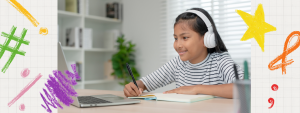 young girl with headphones doing homework on macbook