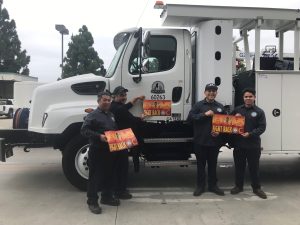 picture of City Public Works staff placing mosquito prevention signs on City vehicles