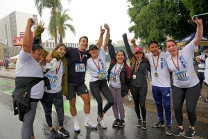 A group of runners celebrate after a 5K