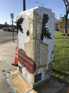 Utility box with art of the historic south main business district landmark