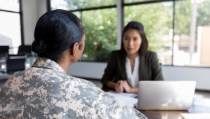 veteran meeting with woman on laptop
