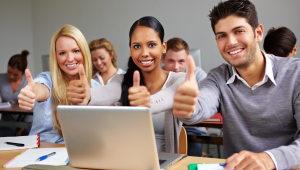 group of adults giving thumbs up in a class