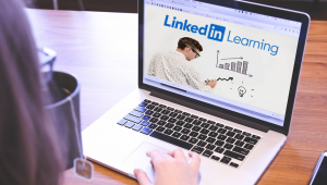 woman on laptop with linkedin learning on screen