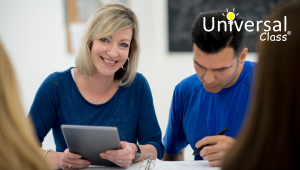 man next to woman on tablet working in front of two ladies