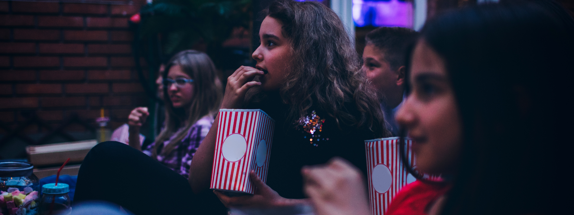 kids eating popcorn and watching movie