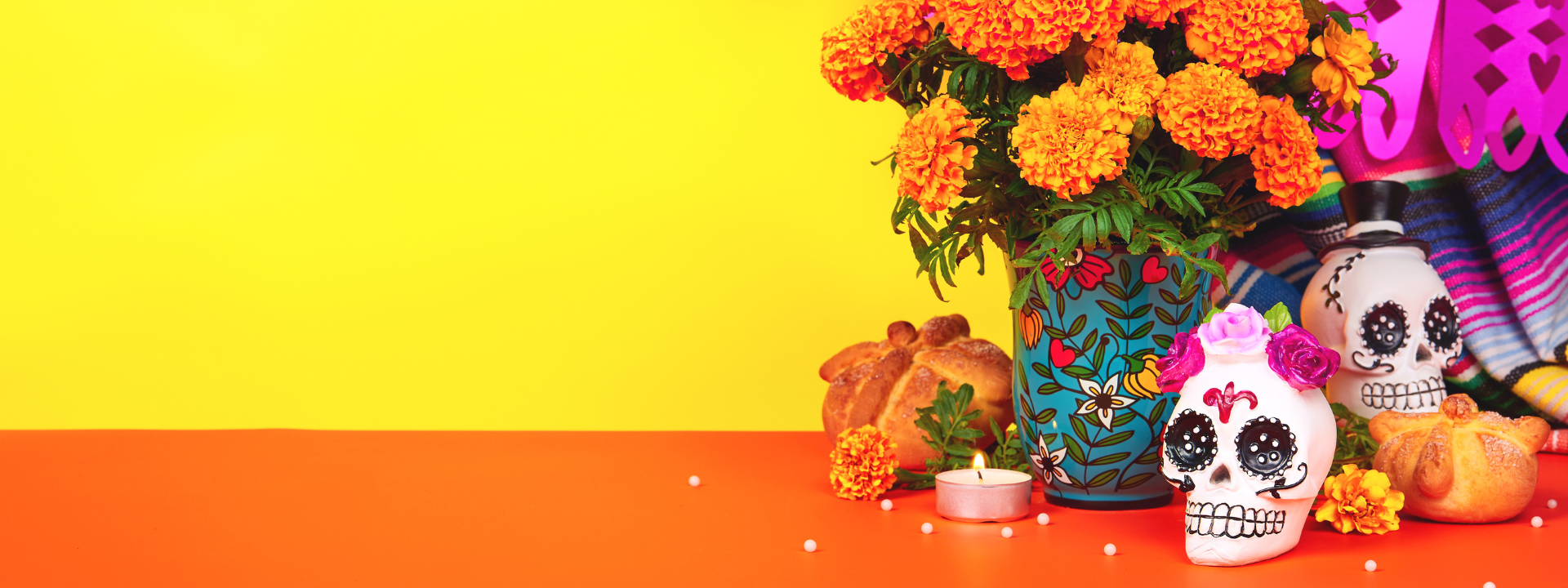 orange flowers, day of the dead papercrafts and decorated skulls