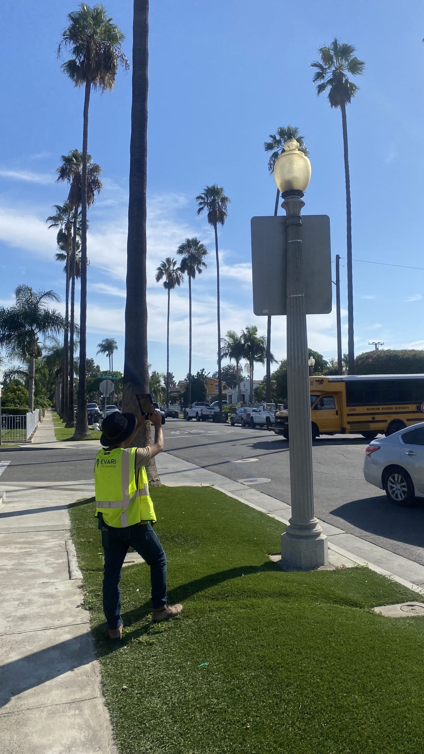 A Picture of an Evari GIS Consultant taking inventory of all the existing streetlights