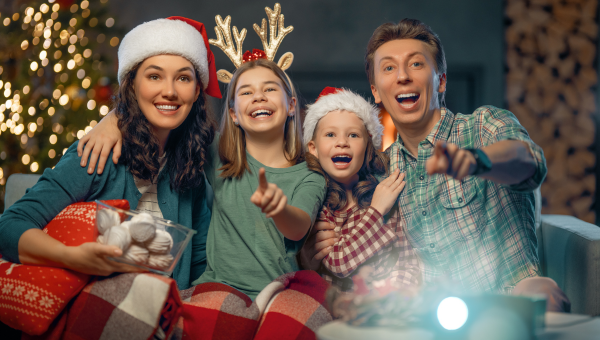 family in holiday attire watching movie