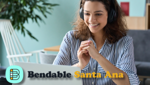 female with headphones in front of laptop with the words "bendable santa ana"