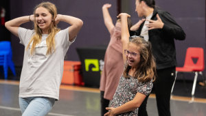 teacher showing kids how dance in a studio