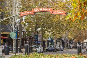Historic Murphy Avenue sign with businesses in background