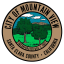 The Mountain View City seal is circular. In the middle there is an image of two trees with mountains and clouds in the background. The rim of the circular seal has lettering that reads 