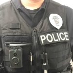 police officer wearing a vest with a body worn camera