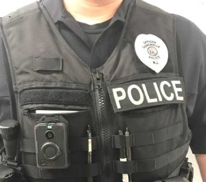 police officer wearing a vest with a body worn camera