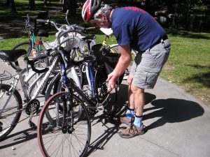 Man locking bike to plaza bike rack