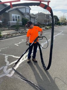 Streets Maintenance Worker Edy Mendoza using the City's new crack sealer equipment as part of the City's Pavement Maintenance Program.