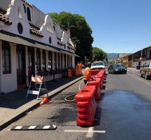 public works staff fill up water barriers