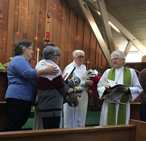 Having the shawls blessed during Sunday service. L to R: Susie Hand, Norah Collins (holding shawls), Linda Dowd, Fr. Jim Thomas, Priest-in-charge, Trinity Episcopal Church, Sonoma, CA