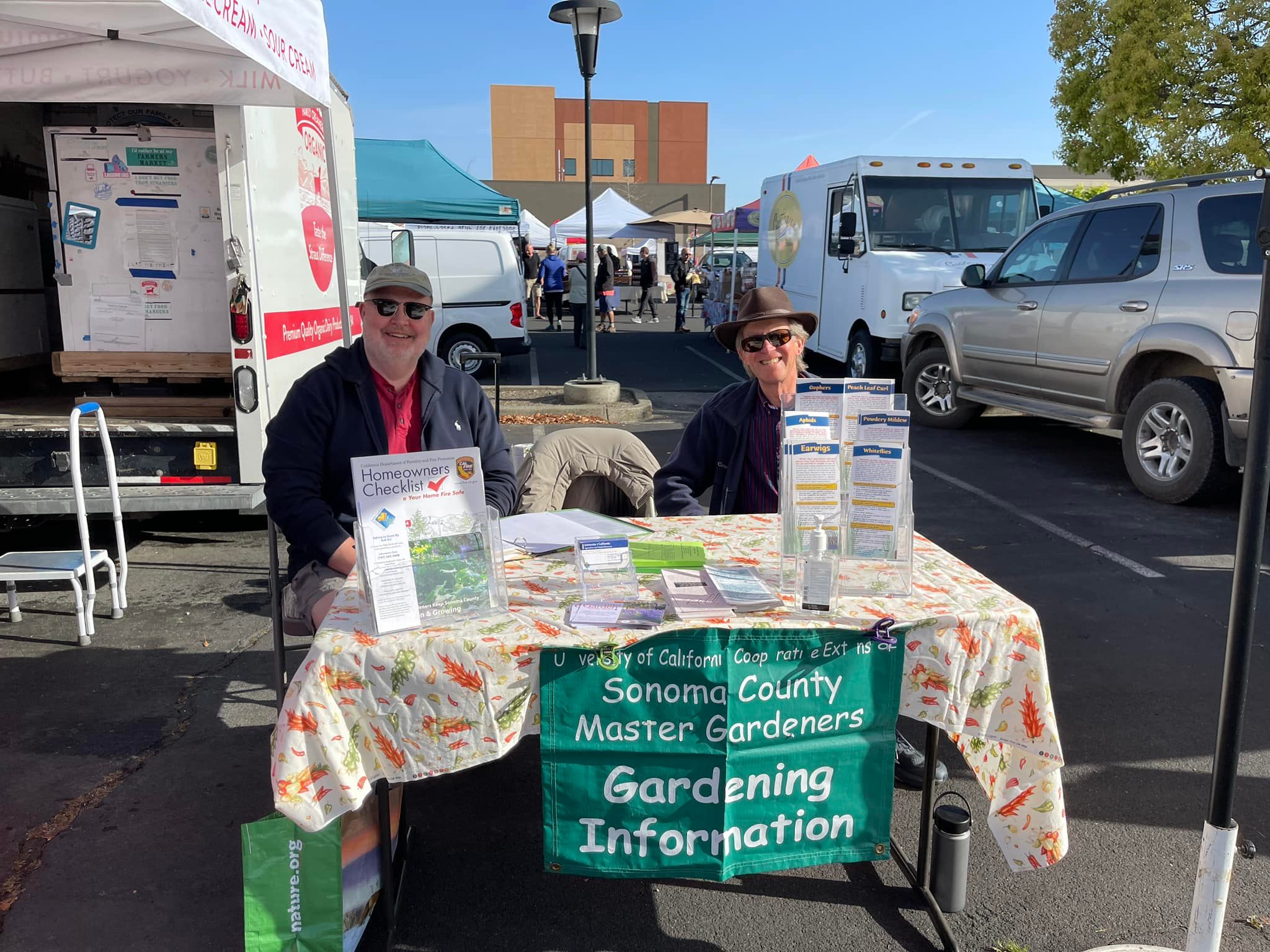 People sitting behind an information table.