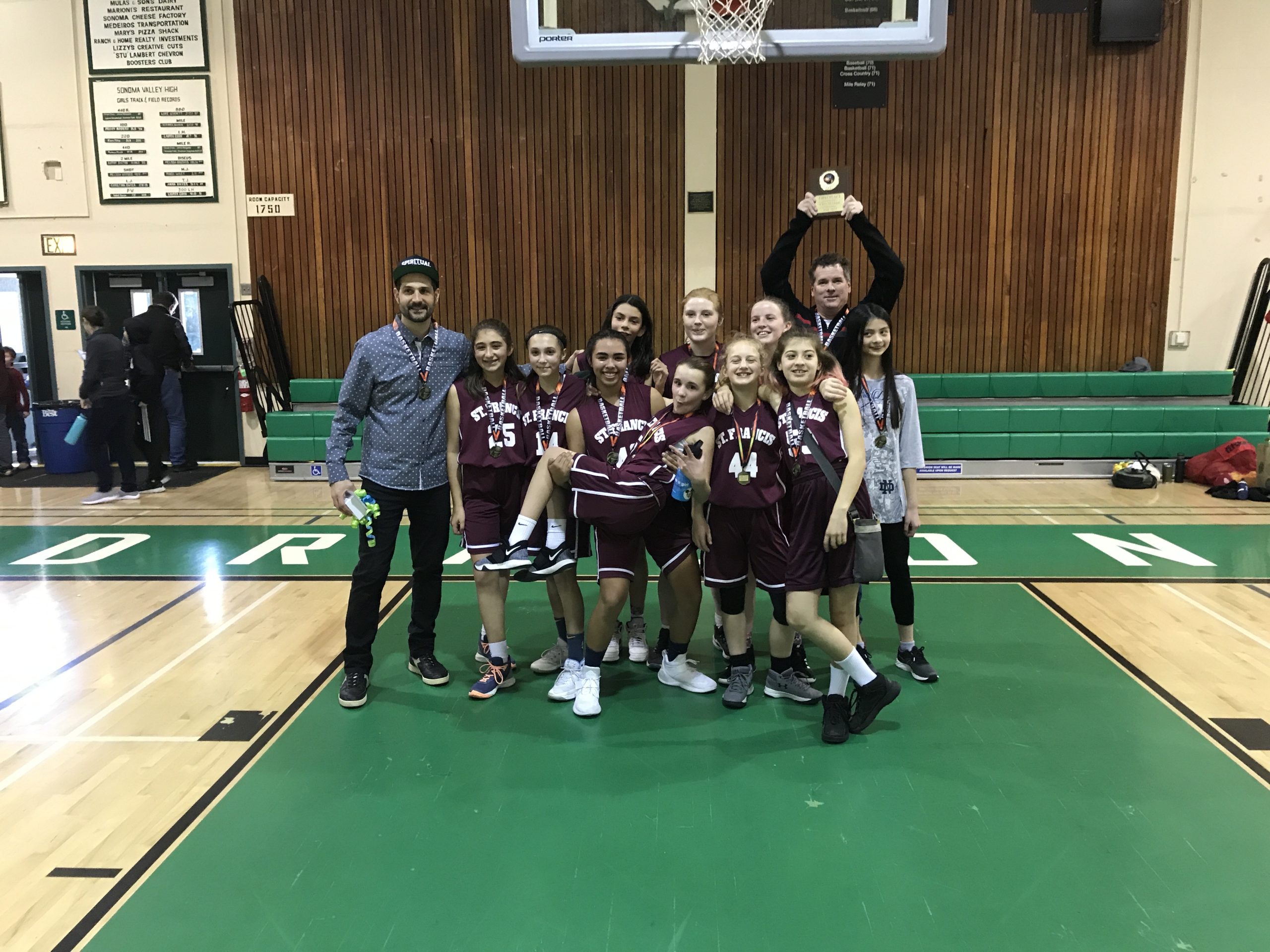 Photo of youth basketball team with trophy.