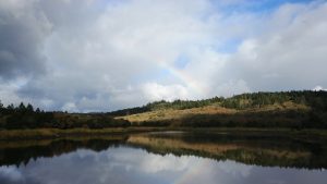 Photo of Lake with Rainbow above.