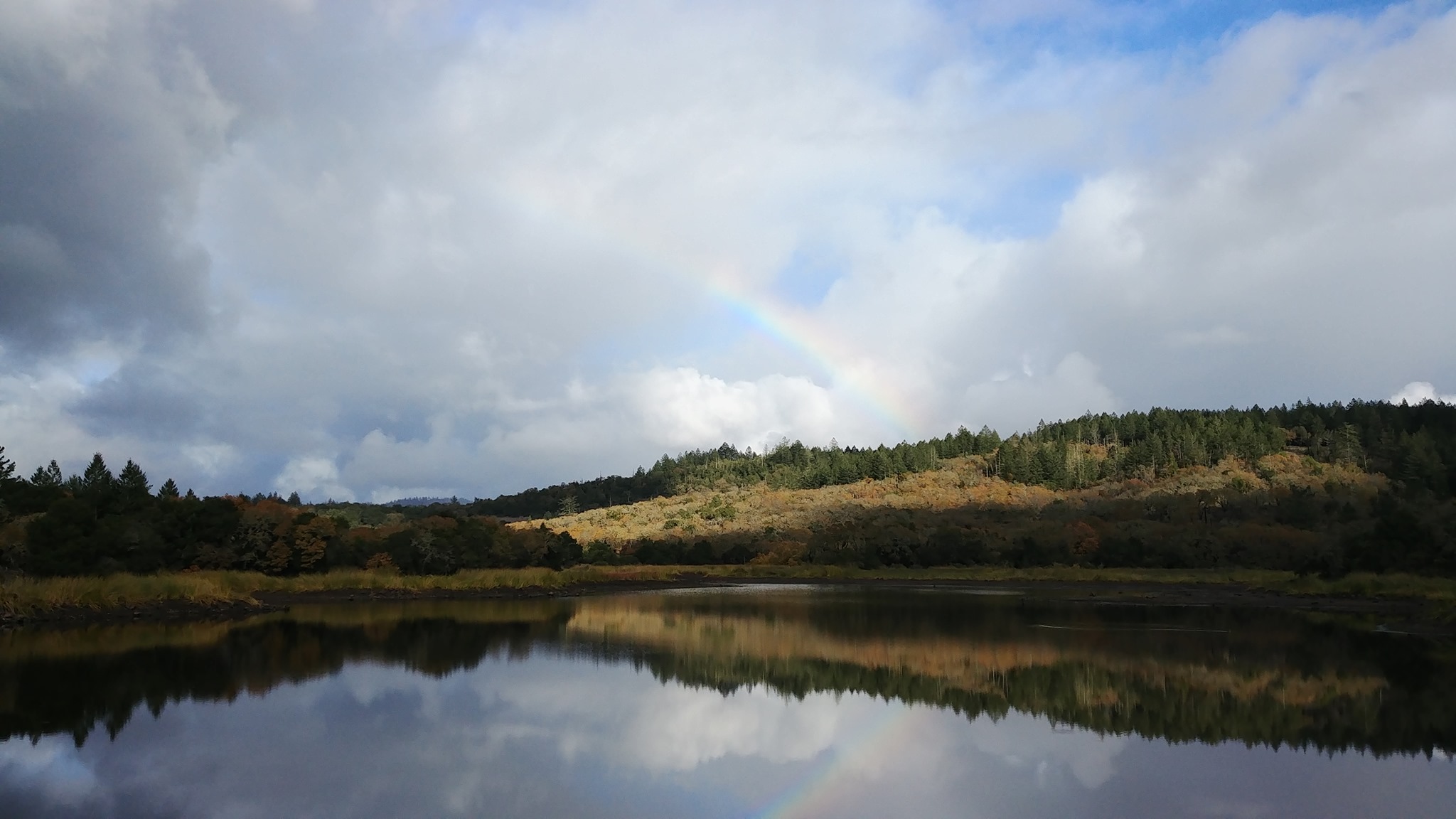 Photo of Lake with Rainbow above.