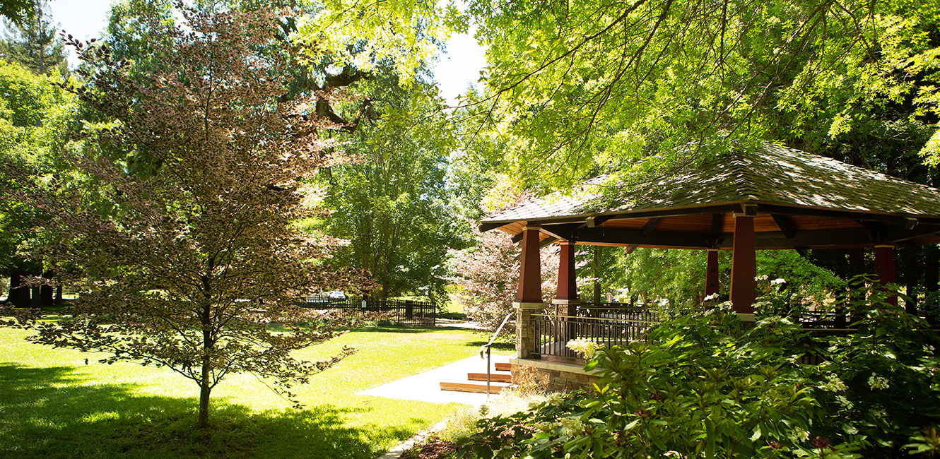 Park with mature trees and gazebo.