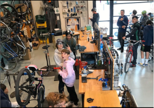 Interior of bike shop with teenagers.