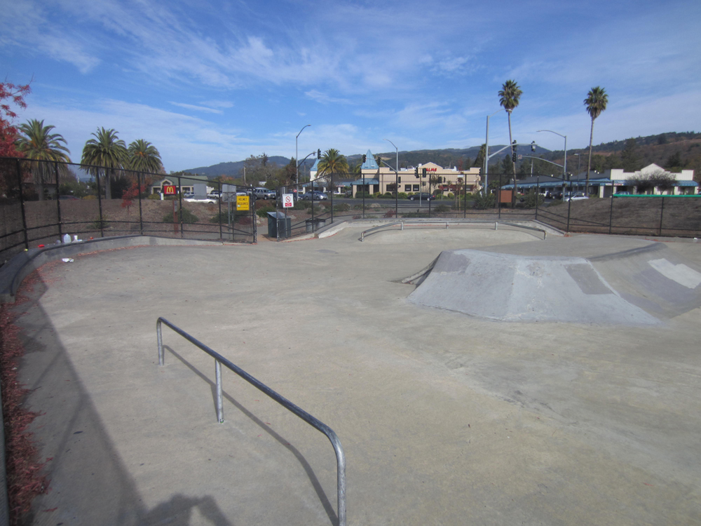 View of concrete skate park facility.