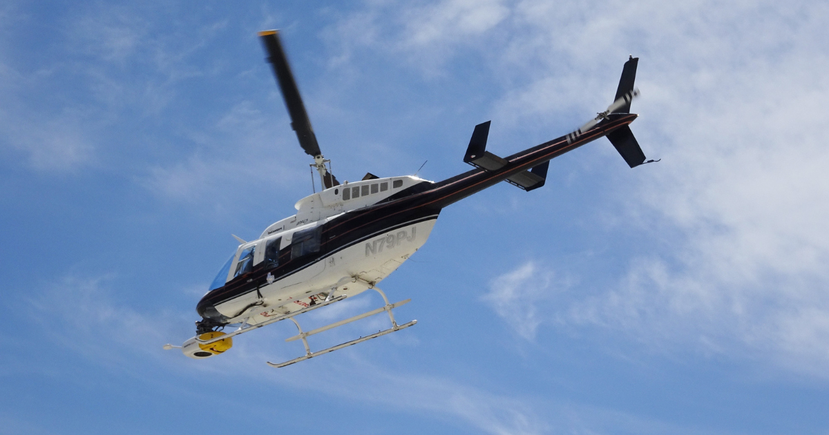 Helicopter in the sky with clouds.