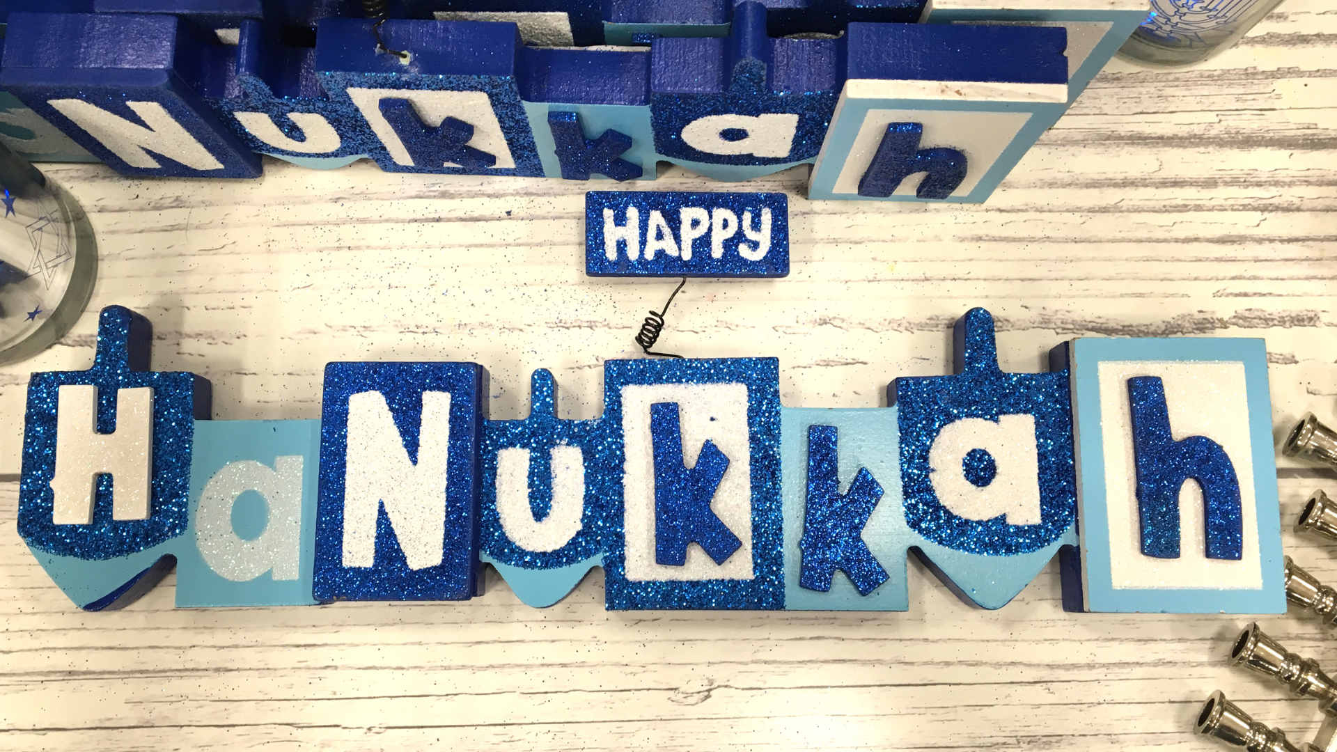 Blocks in shades of blue that spell "Hanukkah"
