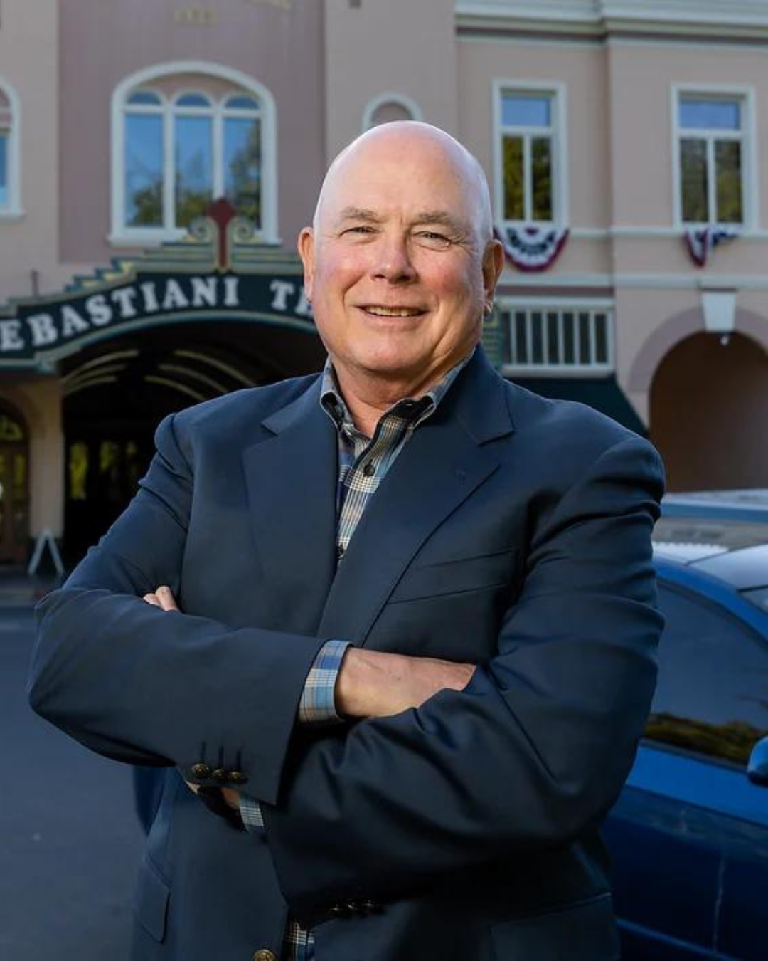 Portrait of a man with a historic theater marquee in the background.