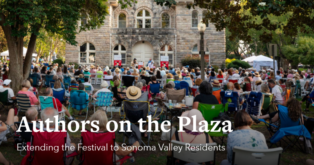 Authors on the plaza event, photo fo crowd of people sitting in a park facing toward a poduim in front of a historic building.