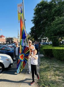 A group of people walking with Pride flags