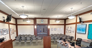 The view of City Council Chambers looking out at an exhibit of artwork.