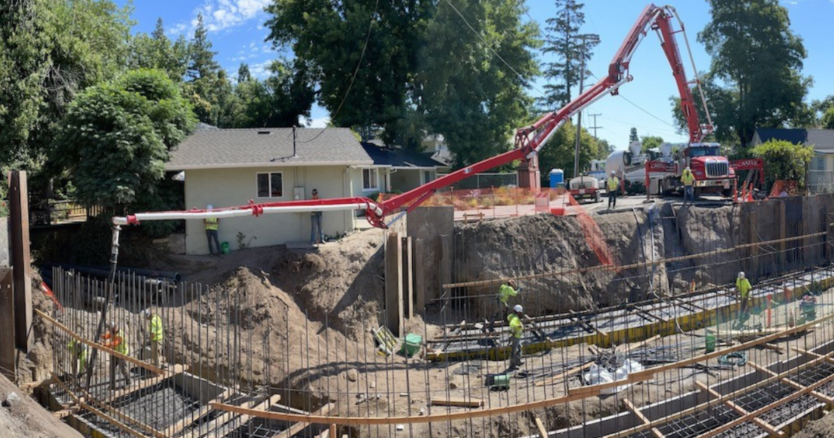 Concrete being poured in a bridge footing.